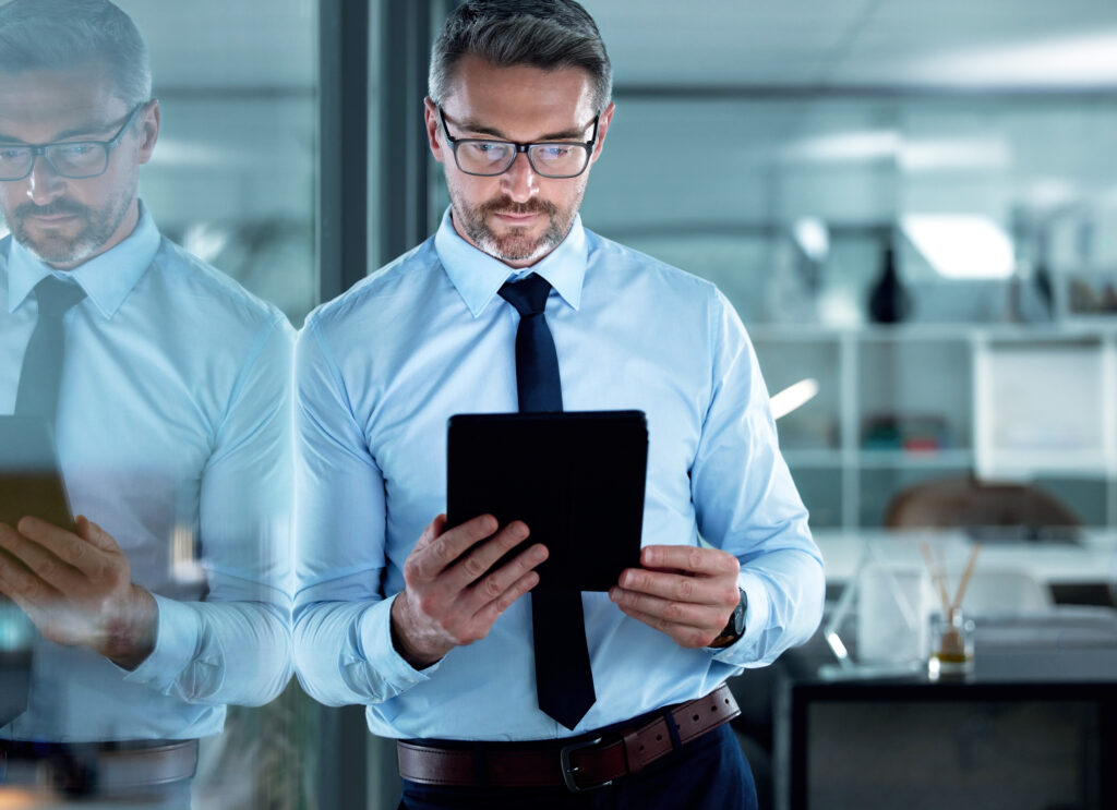 Shot of a businessman using a digital tablet at the office.