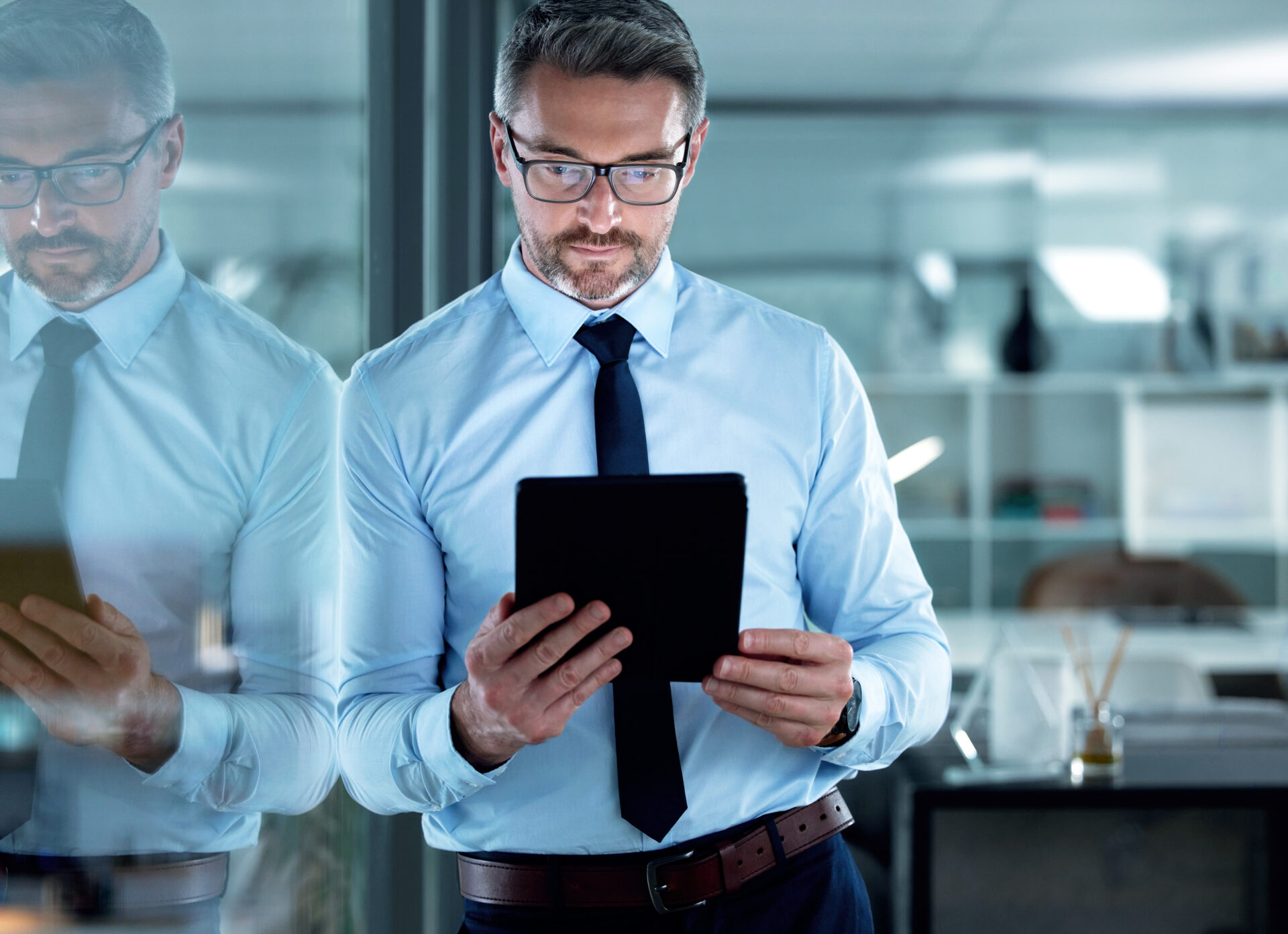 Shot of a businessman using a digital tablet at the office.